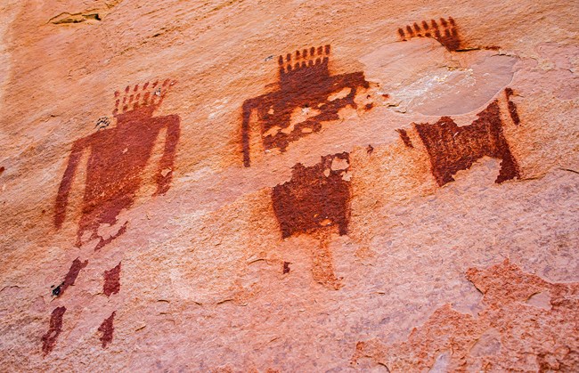 Petroglyphs or painted images on the rocks at Jones Hole depict humanoid figures.