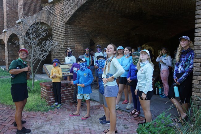 Students talking to a tour guide in a brick fort