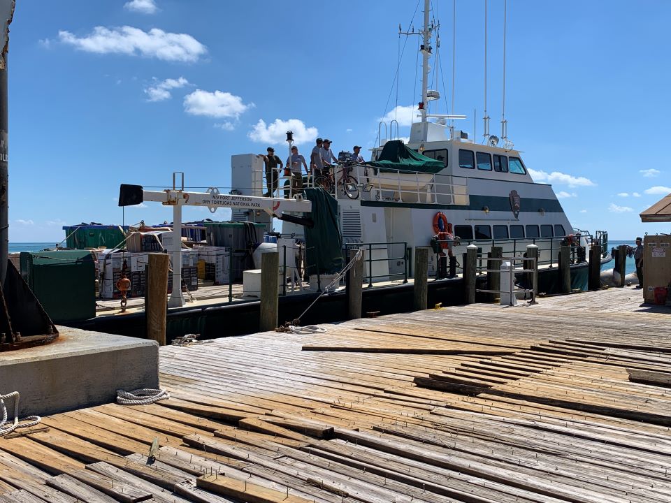 Damaged dock with ship moored to it.