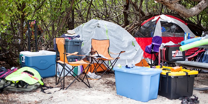 A campsite with food, water and a tent. A campsite with food, water and a tent.