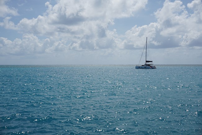 A sailboat floating on blue ocean waters