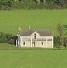 Old farmhouse in green field