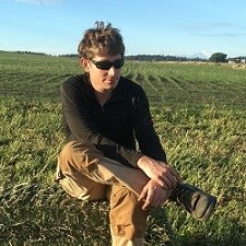 Man sitting in farm field