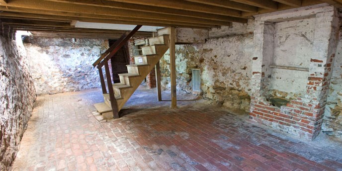 Basement of Edgar Allan Poe House showing staircase and false chimney.