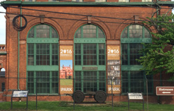 Front of Laboratory Building 5. Two banners celebrating the National Park Service hang on the brick facade. Front of Laboratory Building 5. Two banners celebrating the National Park Service hang on the brick facade.