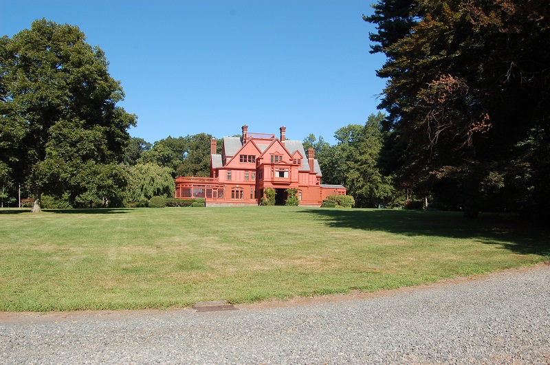 Glenmont Estate Photograph of the Glenmont Estate. There is a large green lawn in the foreground and the salmon colored Glenmont home in the distance.