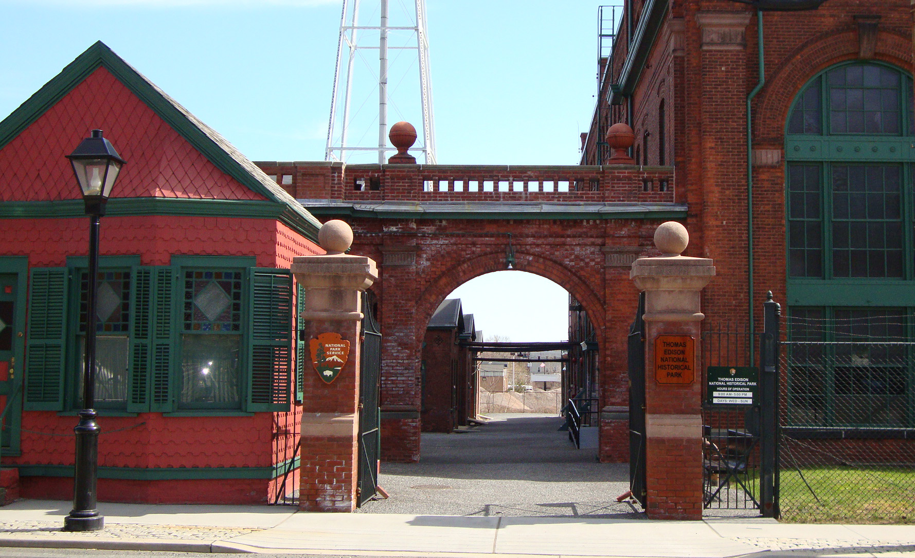 Brick buildings with open black iron gate