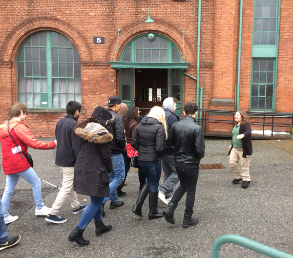 Group of students following a volunteer into the main laboratory building.