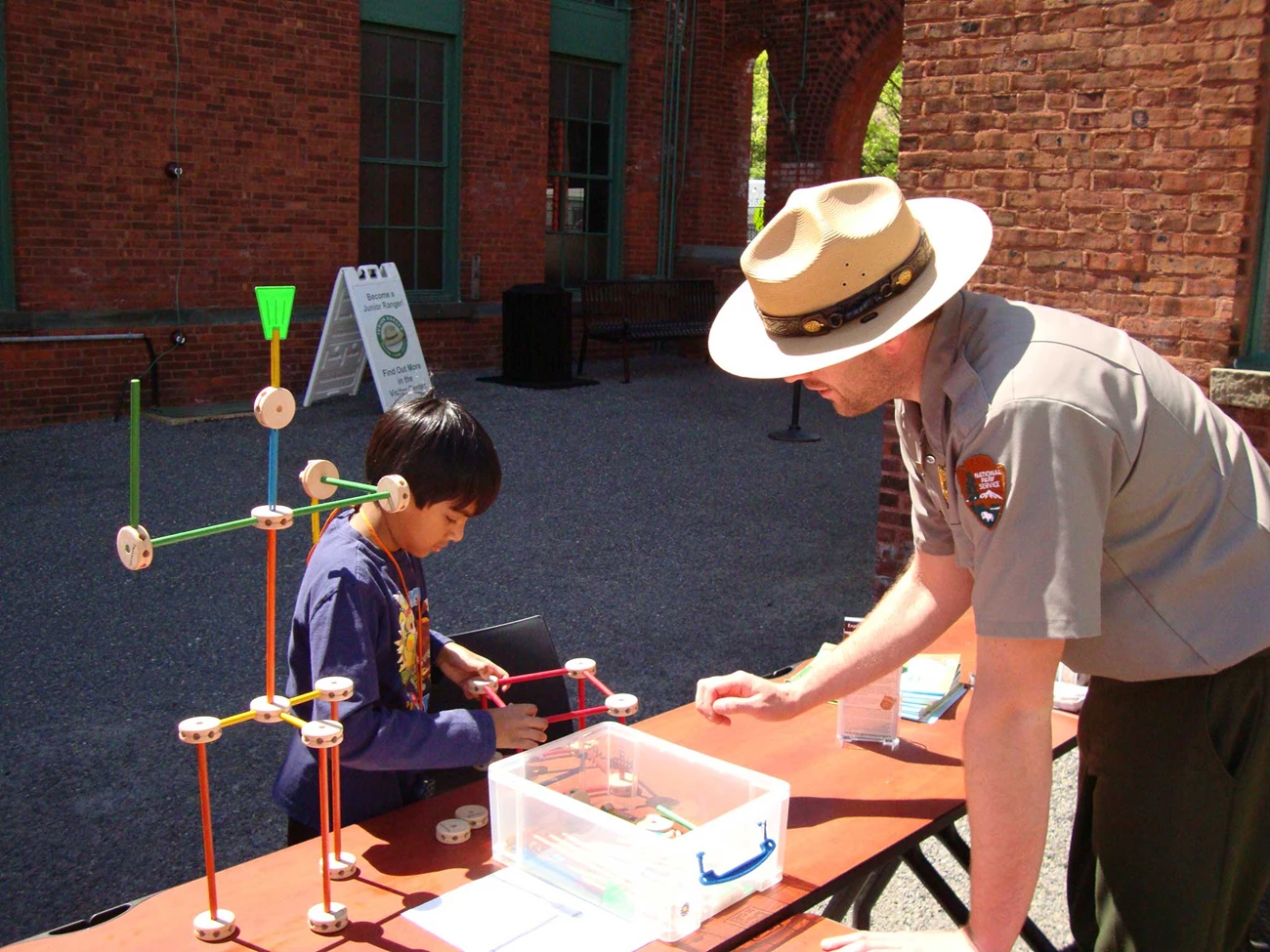 Young boy working with Tinker Toys inventing a new computer.
