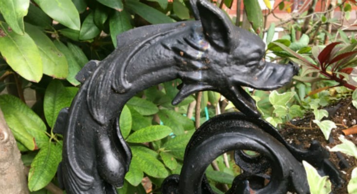 Metal Planter with close up of decorative dragon handle.  This photo shows the planter after conservation work.