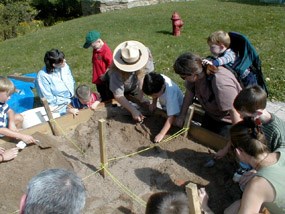 Children digging for artifacts in sandbox demonstration