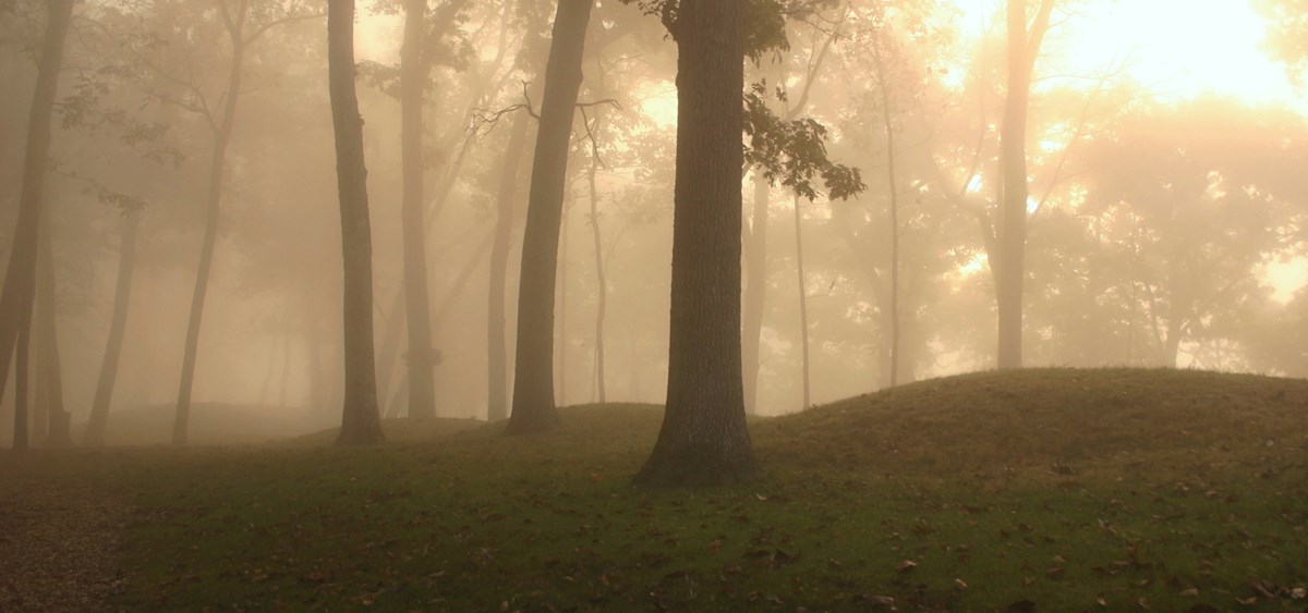 Prehistoric burial mounds on foggy morning