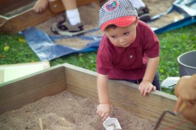 Kids Archeology Day 2005 Child in mock dig sandbox