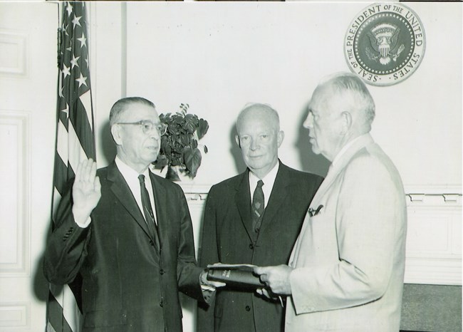 Blog Mc Ike with John Bragdon General Bragdon, standing left, takes an Oath of Office with his hand on a bible. President Eisenhower stands in center of photograph