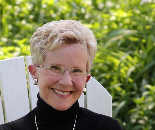 An image of a woman seated outdoors