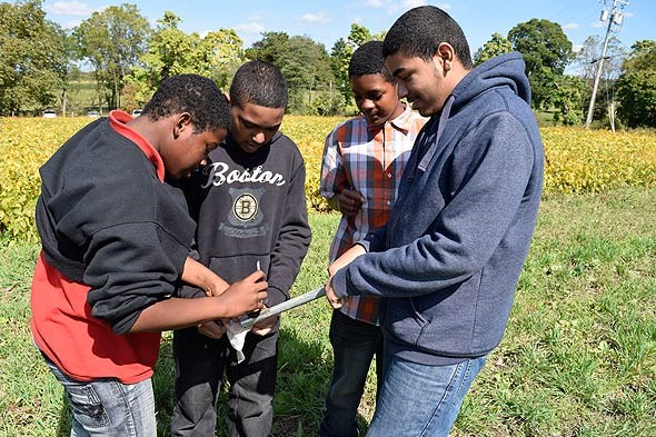 Students extract soil samples from the President's cropland for testing. Students extract soil samples from the President's cropland for testing.