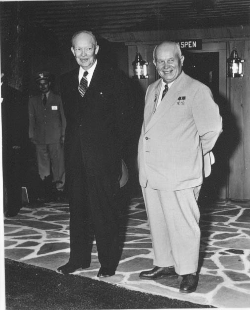 Dwight Eisenhower and Nikita Khrushchev smile while standing in front of the Aspen Lodge at Camp David.