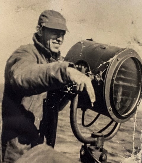 A black and white photo of Louie F. Barnett at a signal station.