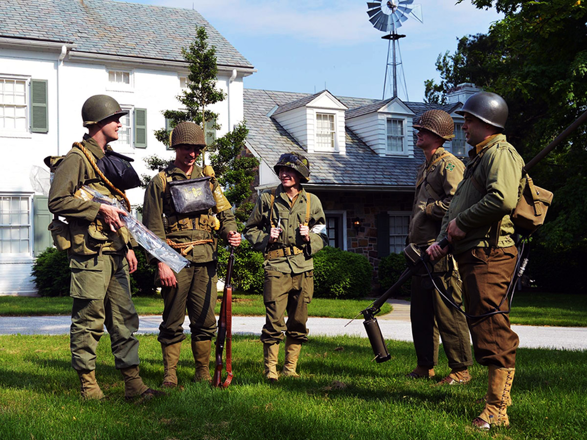 WWII reenactors posing in front of the Eisenhower home