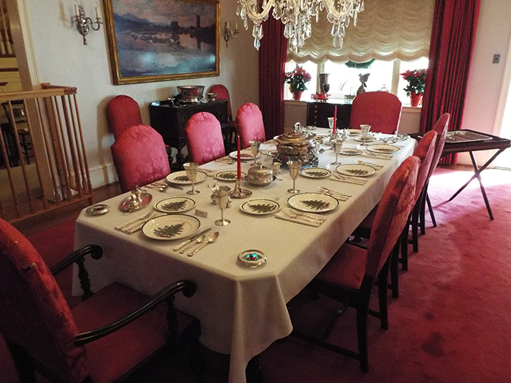 A dining room table is set with Christmas China at the Eisenhower home.