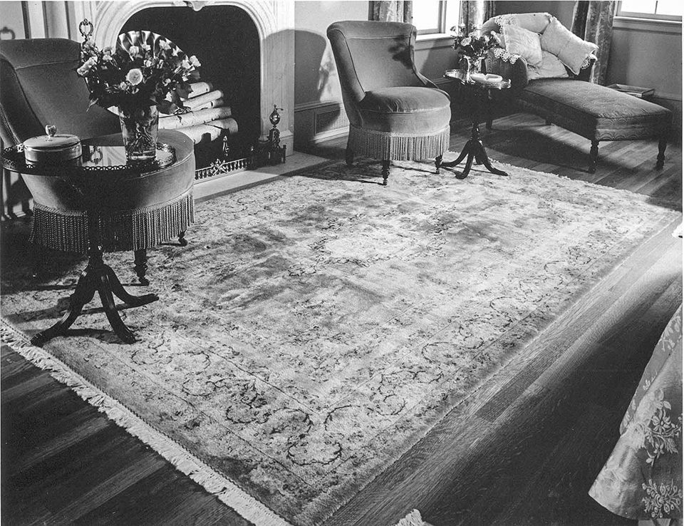 Eisenhower National Historic Site for the reproduction of one of three Iranian rugs missing from the Eisenhower home master bedroom exhibit. Black and white photo of an Iranian rug, two round chairs, and a chaise lounge in front of a fireplace.