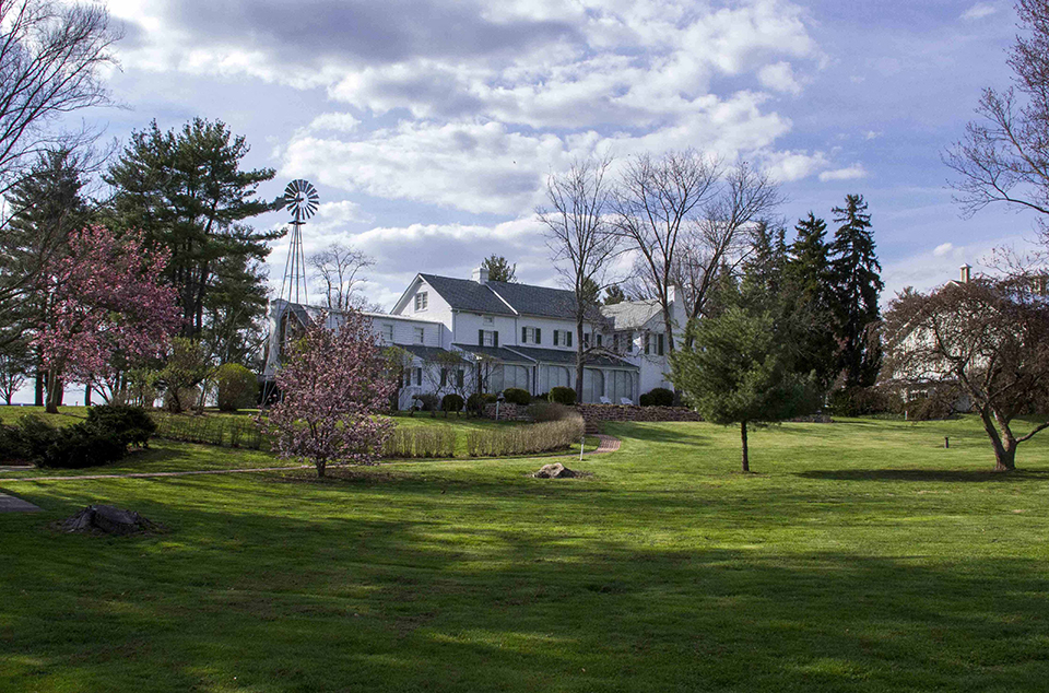 The Eisenhower home. The Eisenhower home as seen in the spring. Green grass is in the foreground and blue skies are visible on the horizen.