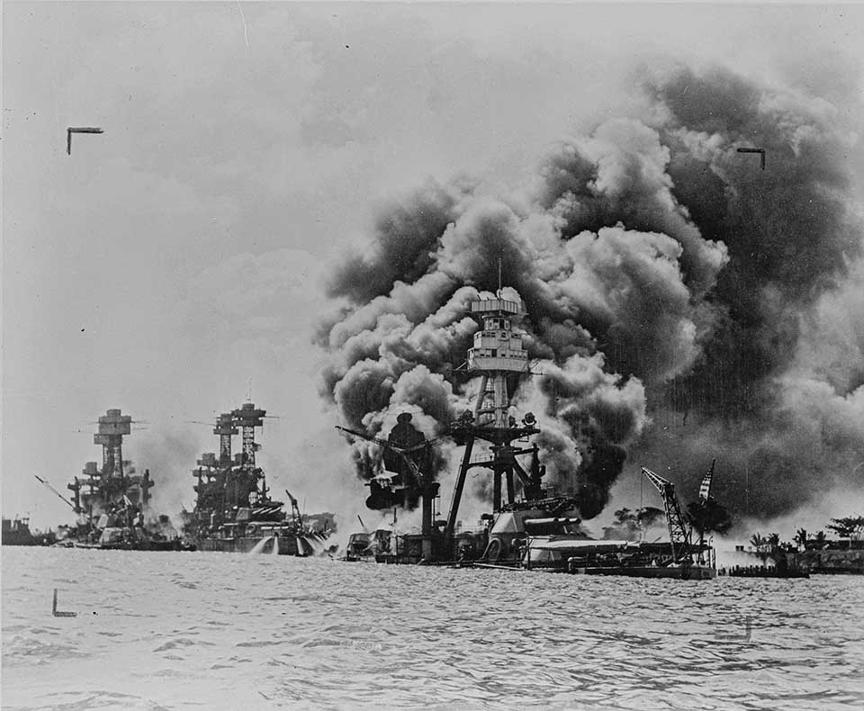 USS Arizona battleship. Black and white photo of battleship engulfed in flames on December 7, 1941.