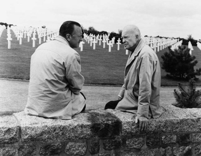 Black and white image of General Eisenhower and Walter Cronkite in Normandy American Cemetery.