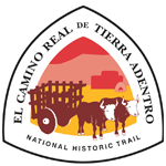 A triangle with "El Camino Real de Tierra Adentro" and an illustration of two oxen pulling a wooden cart.