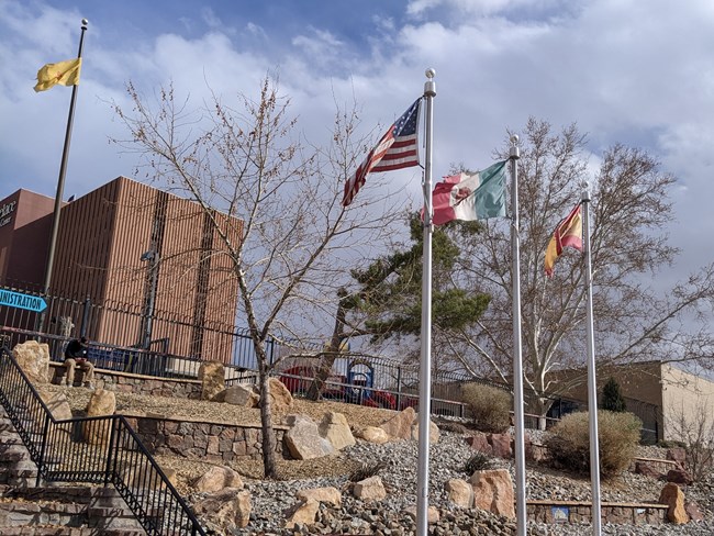 Flags of the United States, Mexico, and Spain along the path in Martineztown Park.