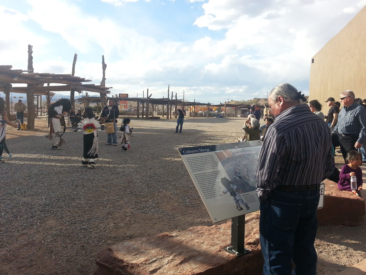 Man viewing new exhibit during a puebloan dance at Poeh Museum Man viewing new exhibit during a puebloan dance at Poeh Museum