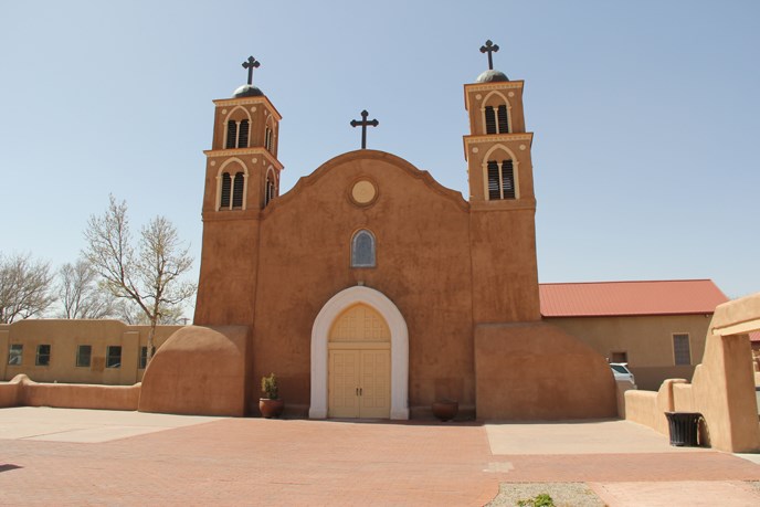 Old San Miguel Church - a mission church, adobe, with large arched doorway and two steeples with two crosses Old San Miguel Church - a mission church, adobe, with large arched doorway and two steeples with two crosses