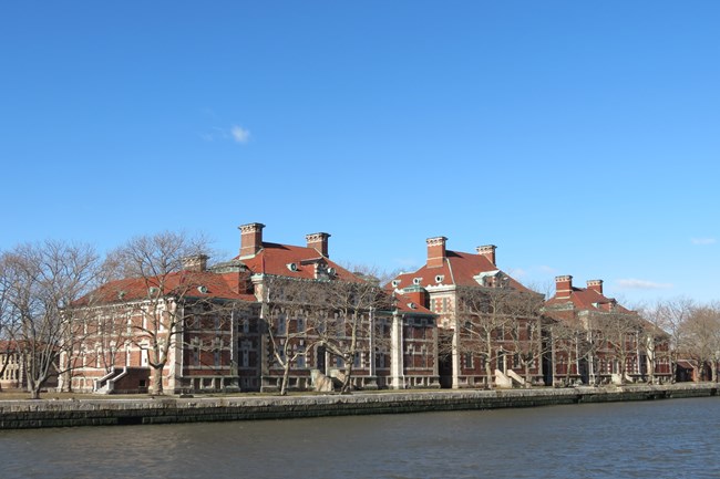 Ferry slip with red brick buildings on an island in the background