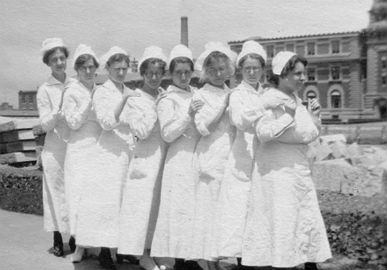 A group of nurses standing outside the hospital complex c. 1920.