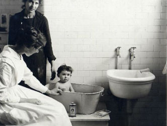 Ellis Island nurse Lillian Wheeler giving a child a bath.