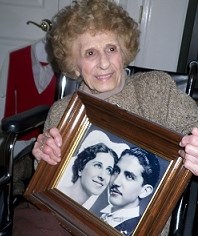 Ellis Island Oral History Project interview subject holding her wedding photograph.