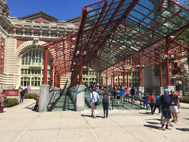 The entrance to the main building on Ellis Island with people in the foreground