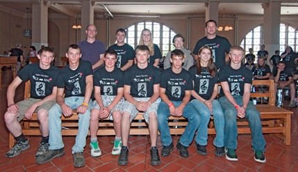 Group photo of students, teachers, and staff involved in building the bench.