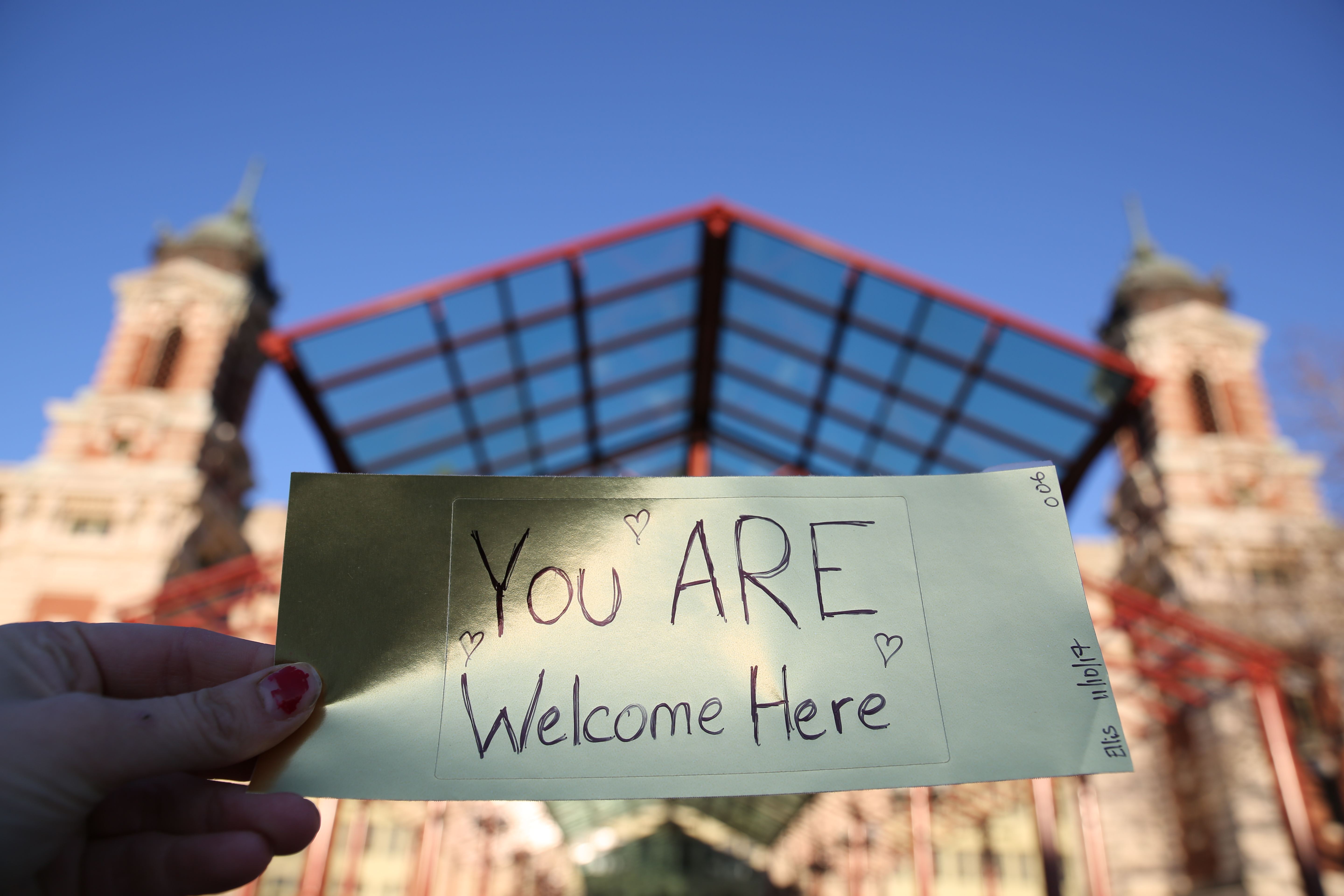 Paper gold brick that says "all are welcome here."