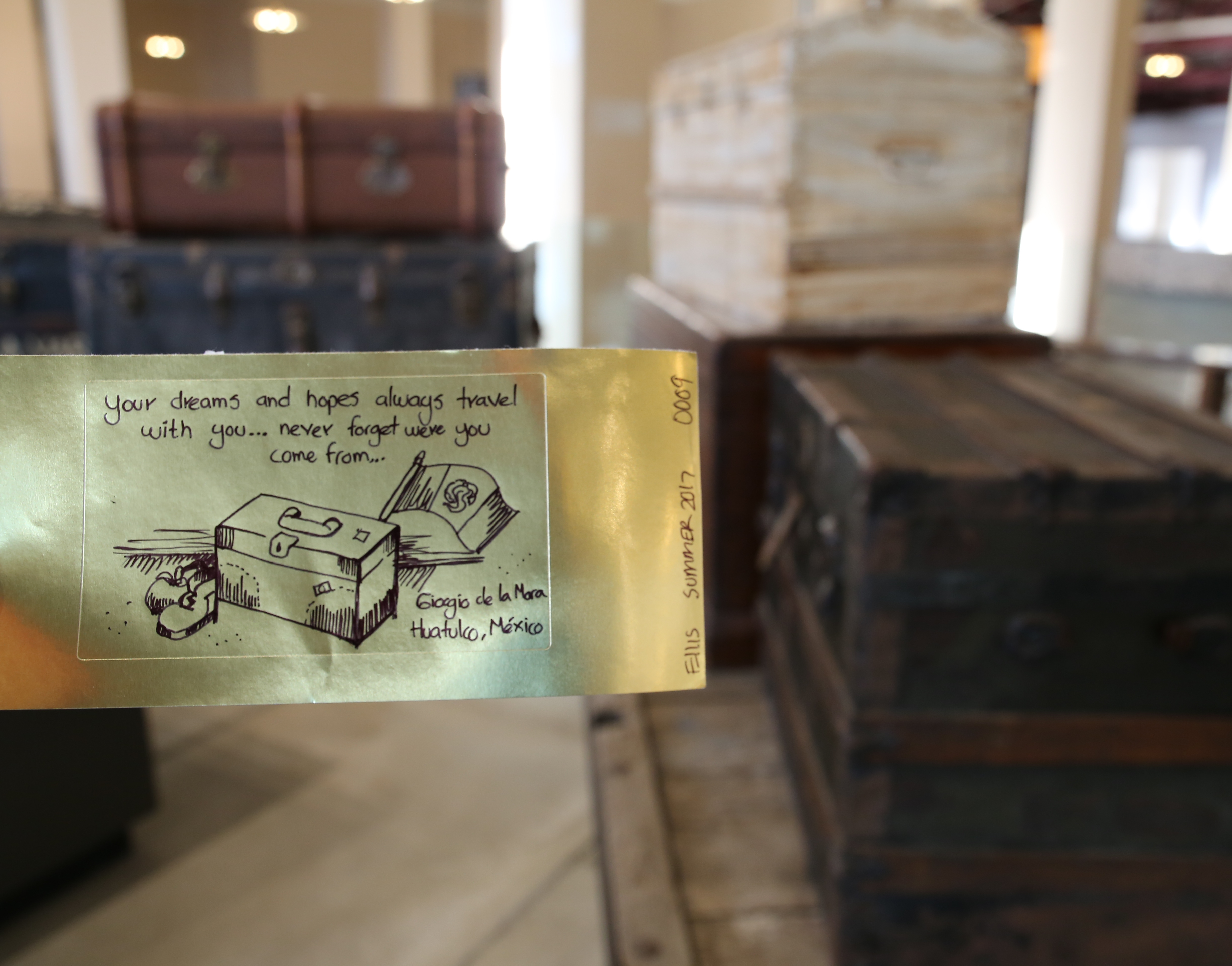 Gold brick with message from visitor with suitcase.