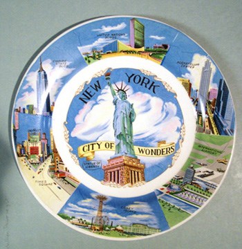 Multi-colored souvenir plate with Statue and other NYC features