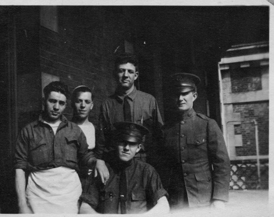 WWI soldiers posed in front of hospital complex c. 1918
