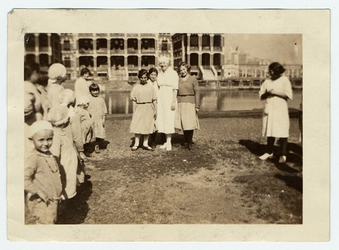 Nurse outside Ellis Island contagious disease ward with patients