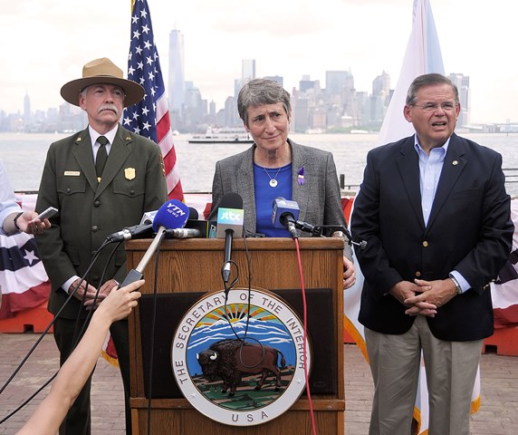 At the reopening of Liberty Island on July 4, 2013, Interior Secretary Sally Jewell listens to a question. National Park Service Director Jon Jarvis and U.S. Senator Robert Menendez stand to either side. At the reopening of Liberty Island on July 4, 2013, Interior Secretary Sally Jewell listens to a question. National Park Service Director Jon Jarvis and U.S. Senator Robert Menendez stand to either side.