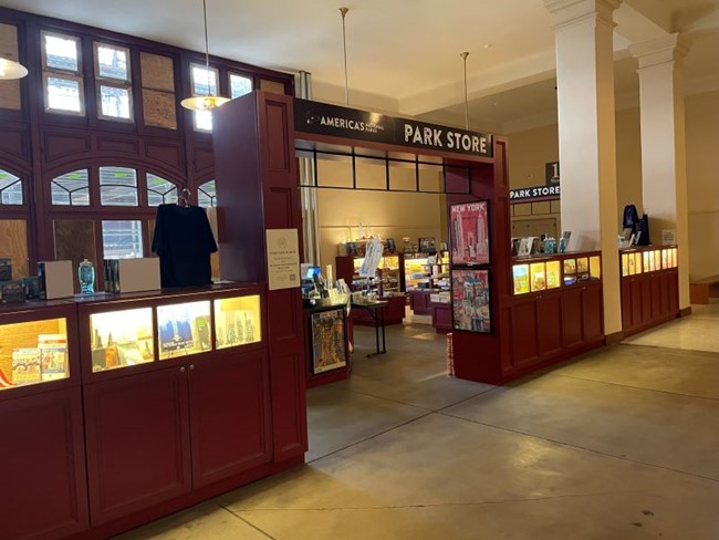 The Eastern National bookstore on Ellis Island. Shelving with merchandise on it.