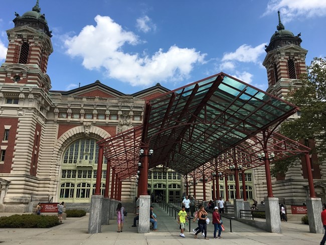 A picture of the entrance with ramp leading into the Ellis Island Main Building.