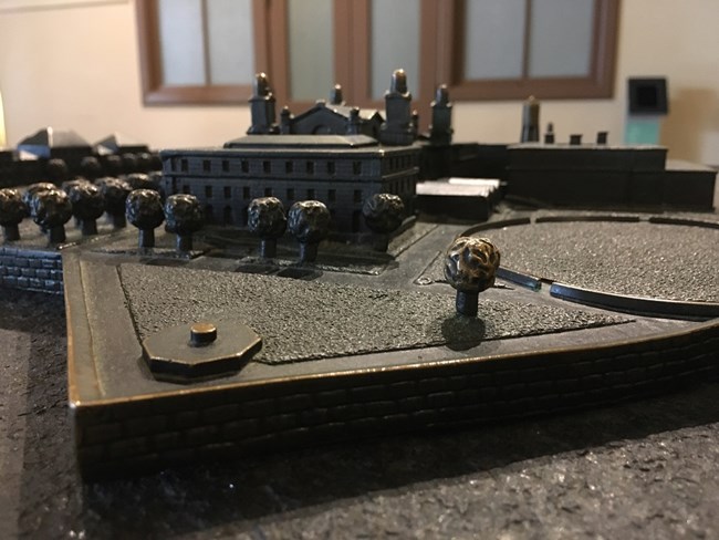 A close view of the tactile Ellis Island metal model.
