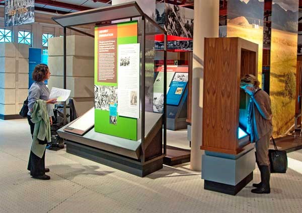 Visitors viewing the Struggle and Survival section of the Journeys: Peopling of America, 1550-1890 exhibit.