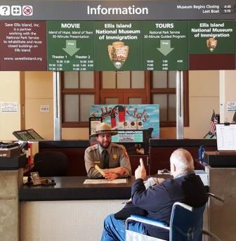 Information desk with ranger and visitor in wheelchair. Information desk with ranger and visitor in wheelchair.