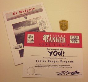 The Junior Ranger badge, book, and certificate from El Malpais National Monument. The Junior Ranger badge, book, and certificate from El Malpais National Monument.